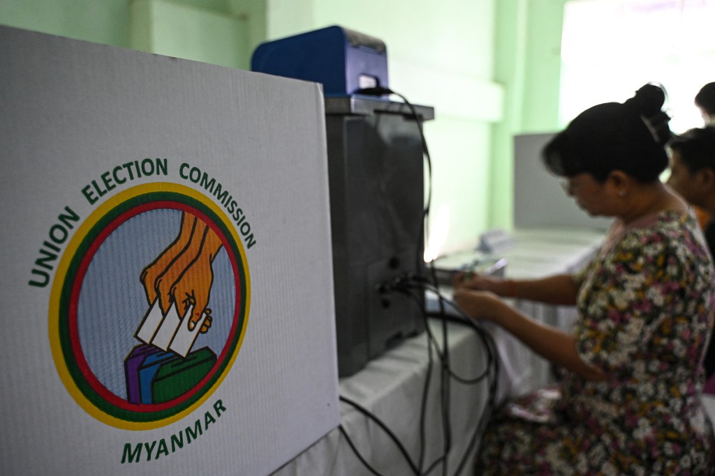 Members of Myanmar's Union Election Commission (UEC) prepare a voting station a day before the start of Myanmar's general election in Yangon on December 27, 2025. (AFP)