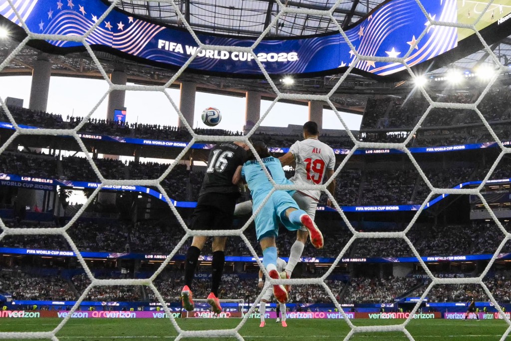 Iran's goalkeeper #01 Alireza Beiranvand clears the ball past New Zealand's defender #16 Finn Surman and Iran's defender #19 Ali Nemati during the 2026 World Cup Group G football match between Iran and New Zealand at Los Angeles Stadium in Inglewood on June 15, 2026. (Photo by Patrick T. Fallon / AFP)