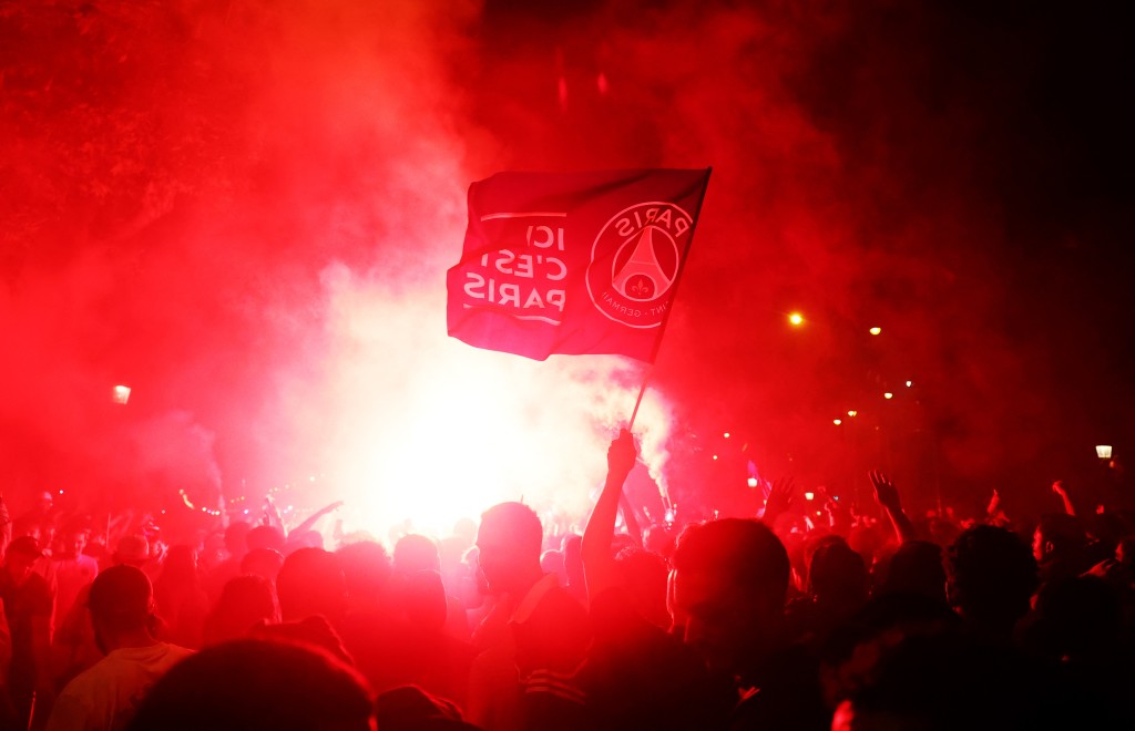 Paris St Germain fans celebrate with flares on the Champs Elysees avenue after winning the Champions League. (Reuters)