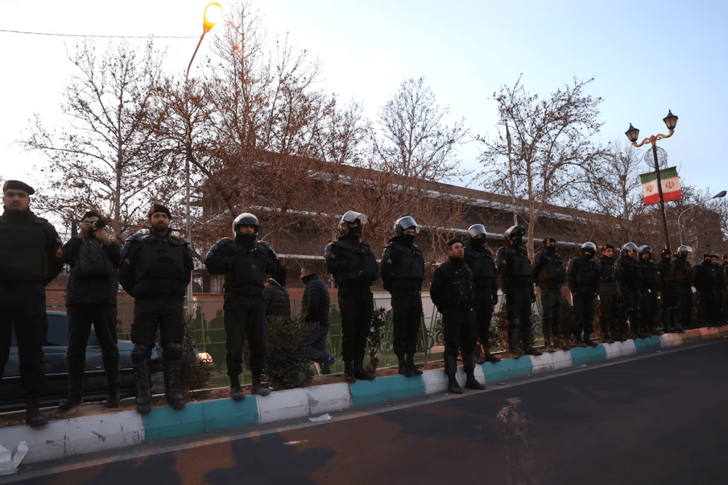 Members of the Iranian police stand guard at a protest in front of the British embassy following anti-government protests in Tehran, Iran, January 14, 2026. Majid Asgaripour/WANA (West Asia News Agency) via REUTERS