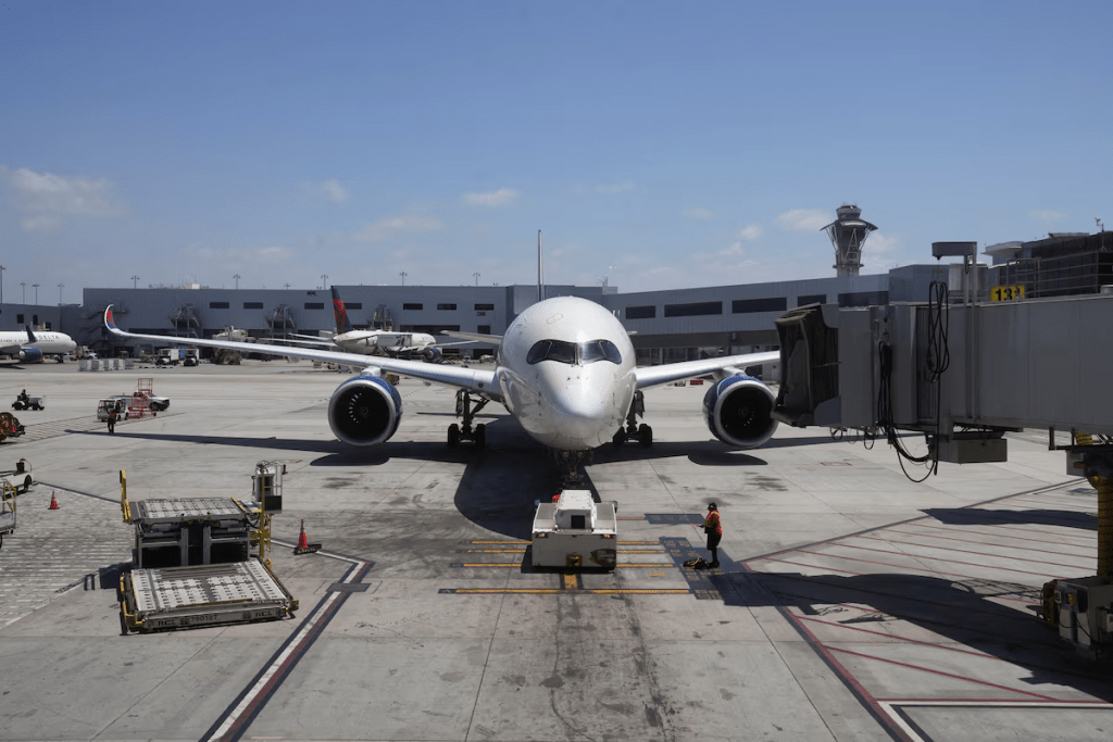 A plane and the air traffic control tower are seen from the Los Angeles International Airport terminal, in Los Angeles, California, U.S. May 14, 2025. REUTERS/Megan Varner/File Photo 