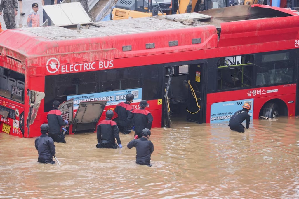 Rescue workers take part in a search and rescue operation near an underpass that has been submerged by a flooded river caused by torrential rain in Cheongju, South Korea, July 16, 2023. REUTERS/Kim Hong-ji