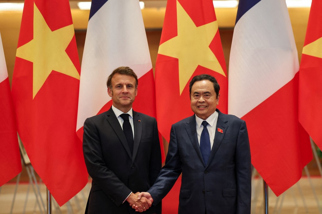 French President Emmanuel Macron and Chairman of Vietnam's National Assembly Tran Thanh Man shake hands at the National Assembly, during Macron's first official trip to the country, in Hanoi, Vietnam, May 26, 2025. (Reuters)