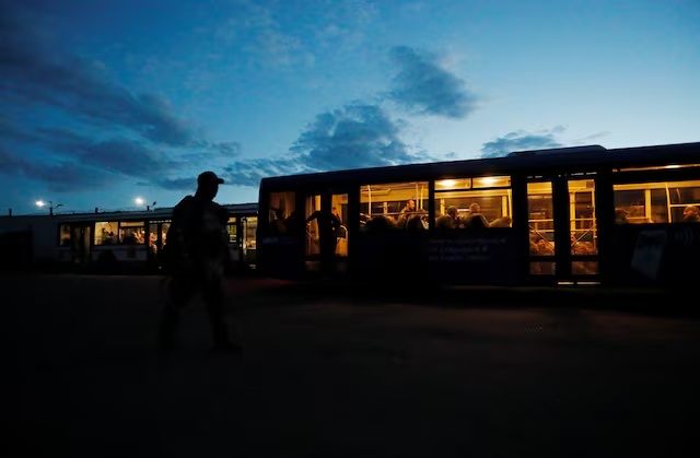 Service members of Ukrainian forces who have surrendered after weeks holed up at Azovstal steel works are seen inside a bus, which arrived under escort of the pro-Russian military at a detention facility in the course of Ukraine-Russia conflict in the settlement of Olenivka in the Donetsk Region, Ukraine May 17, 2022. REUTERS/Alexander Ermochenko/File Photo