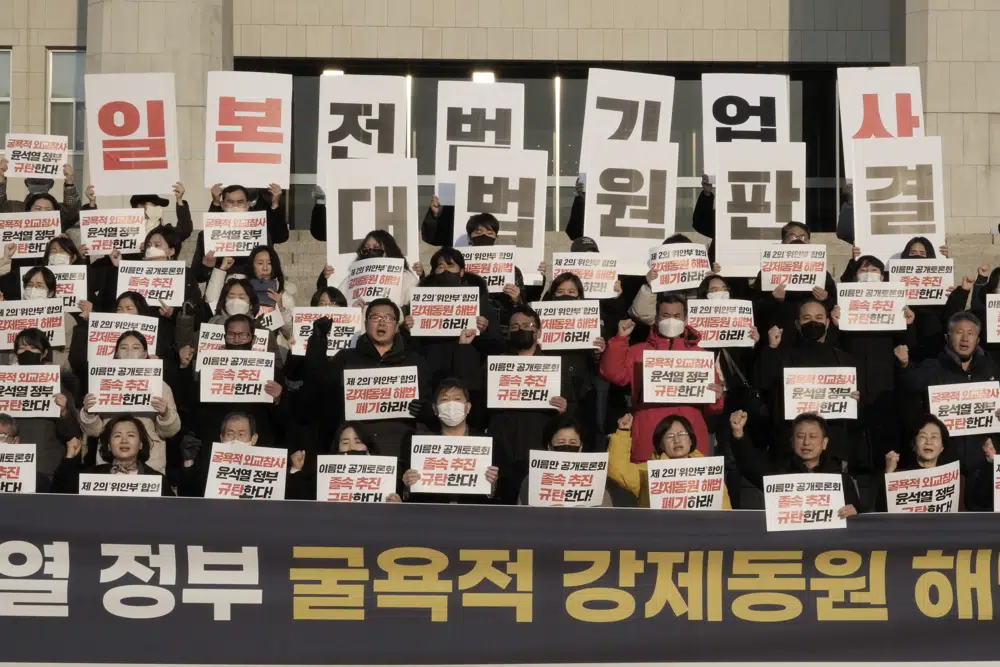 Members of a civic group seeking compensation from Japanese firms over forced labor during World War II and opposition lawmakers stage a rally to oppose the government's reported resolution to the issue outside the National Assembly in Seoul. (AP) Members of a civic group seeking compensation from Japanese firms over forced labor during World War II and opposition lawmakers stage a rally to oppose the government's reported resolution to the issue outside the National Assembly in Seoul. (AP)
