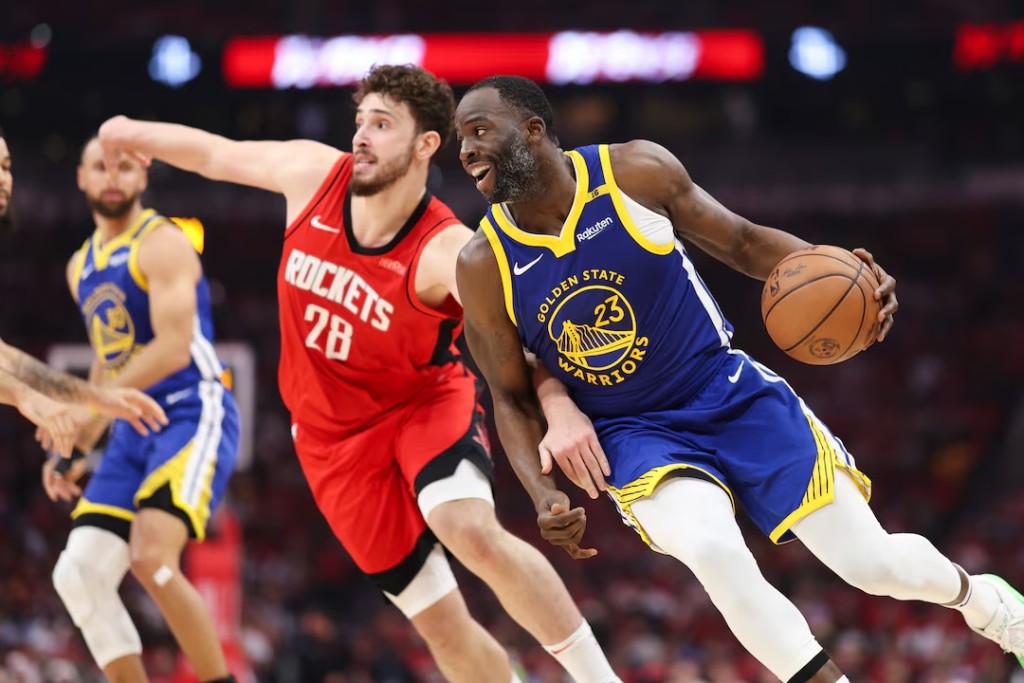 Golden State Warriors forward Draymond Green (23) dribbles the ball as Houston Rockets center Alperen Sengun (28) defends during the second quarter during game two. (Reuters)