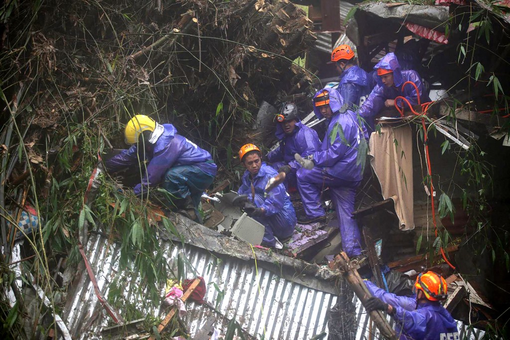 Rescuers sift through rubble as they search for survivors after a rain-drenched mountainside collapsed on several houses in Baguio City, north of Manila, on August 10, 2026.