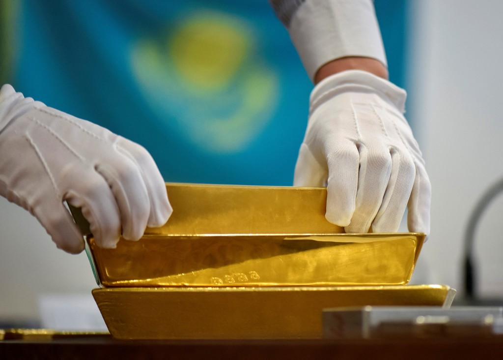 An employee places gold bars in the Kazakhstan's National Bank vault in Almaty, Kazakhstan, September 30, 2016.  REUTERS