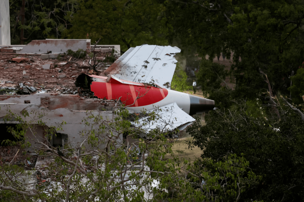 A tail of an Air India Boeing 787 Dreamliner plane that crashed is seen stuck on a building after the incident in Ahmedabad, India, June 12, 2025. REUTERS/Amit Dave/File Photo