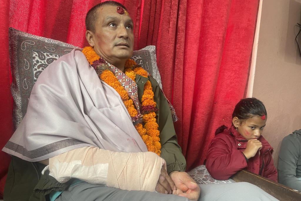 Photo by ANUP OJHA / AFP  Nepali flood survivor Kabir Maharjan, who was rescued from a hydropower project tunnel, takes part in an interview AFP at his home in Kirtipur on September 25, 2026, after being discharged from hospital.