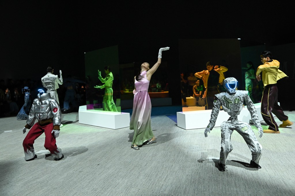 TOPSHOT - Humanoid robots and models perform as they present creations at Galaxy Corporation's "Mach33: Physical AI Fashion Show" in Seoul on May 28, 2026. (Photo by Pedro PARDO / AFP)