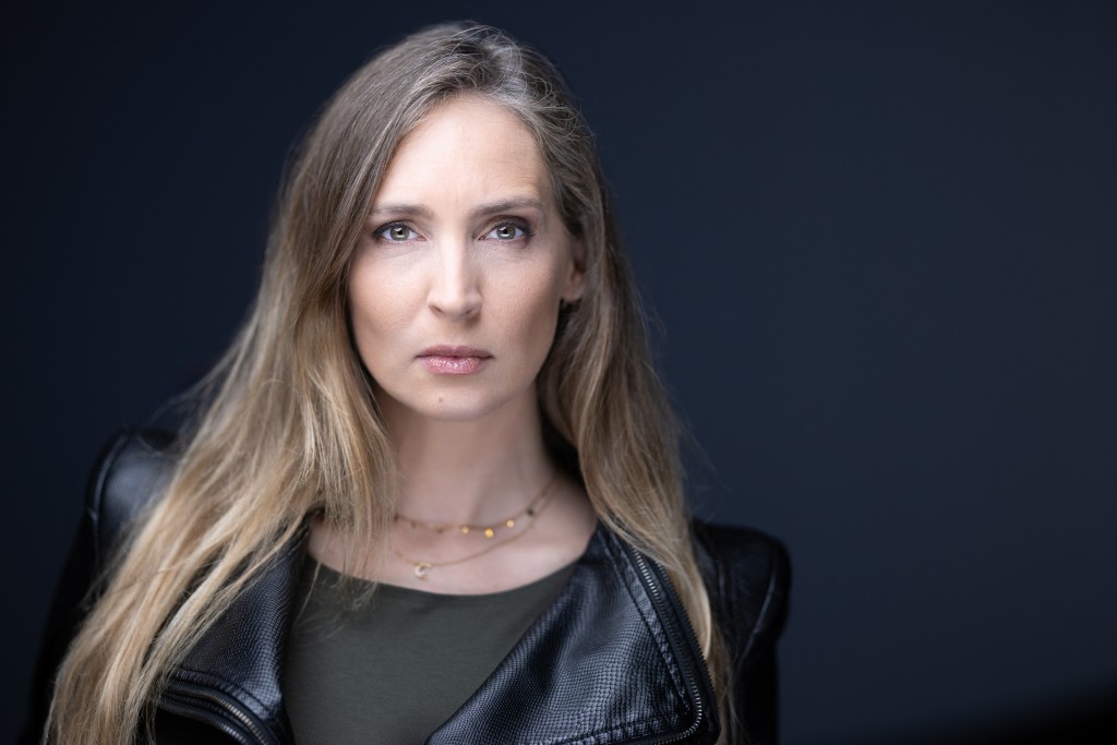Photo by JOEL SAGET / AFP  Former French model Juliette G. poses during a photo session in Paris on March 10, 2026.
