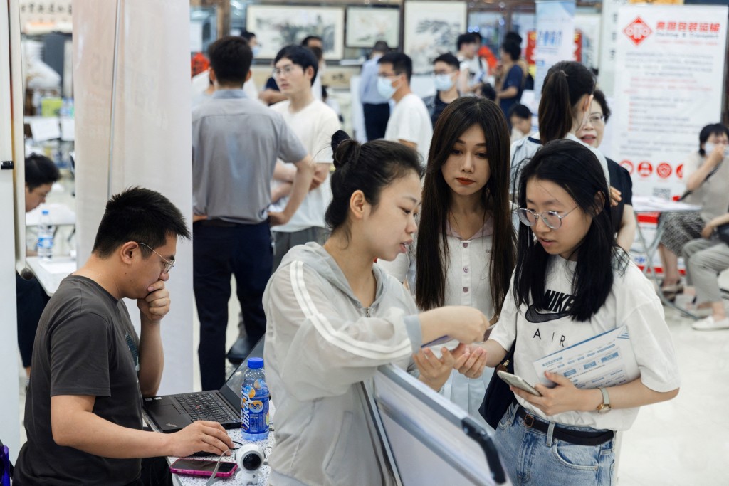  People attend a job fair in a mall in Beijing, China. REUTERS
