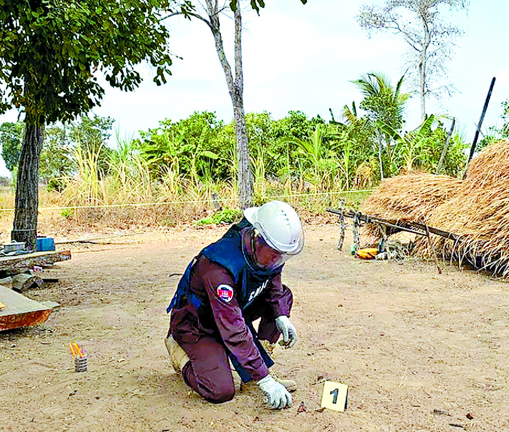 A deminer inspects fragments of a decades-old rocket-propelled grenade after it exploded. AP A deminer inspects fragments of a decades-old rocket-propelled grenade after it exploded. AP
