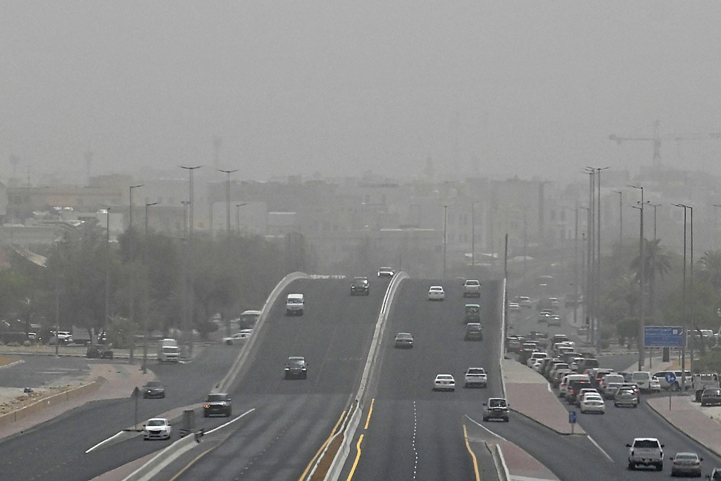 Vehicles drive through low visibility conditions during a sandstorm in Kuwait City on August 20, 2026. (Photo by YASSER AL-ZAYYAT / AFP)