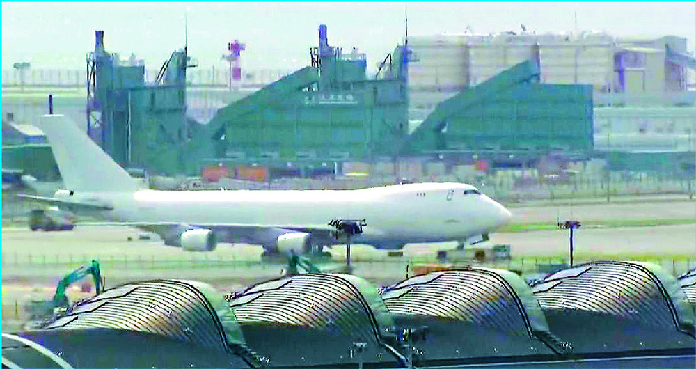The cargo plane with a blown tire is towed away. The incident forces the closure of the north runway. The cargo plane with a blown tire is towed away. The incident forces the closure of the north runway.