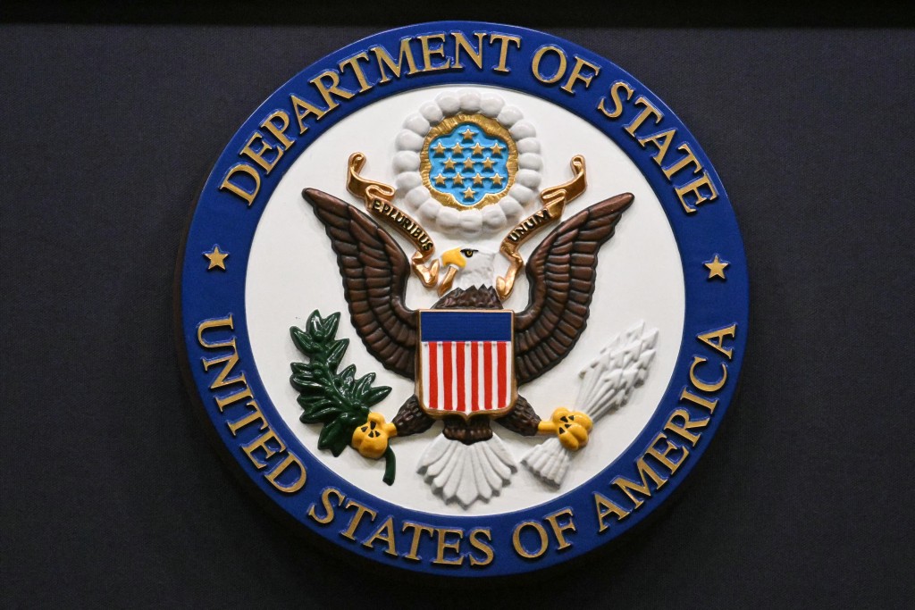 The seal of the US Department of State is seen on the lectern during an end-of-year press conference in the State Department Press Briefing Room in Washington, DC on December 19, 2025. (Photo by Mandel NGAN / AFP)