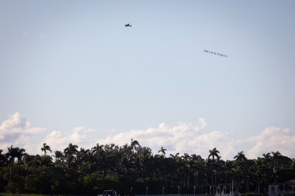 A plane tows a banner that reads "Trump is in the Epstein files" near U.S. President Donald Trump's residence at Mar-a-Lago in Palm Beach, Florida, U.S., October 23, 2025. REUTERS/Marco Bello