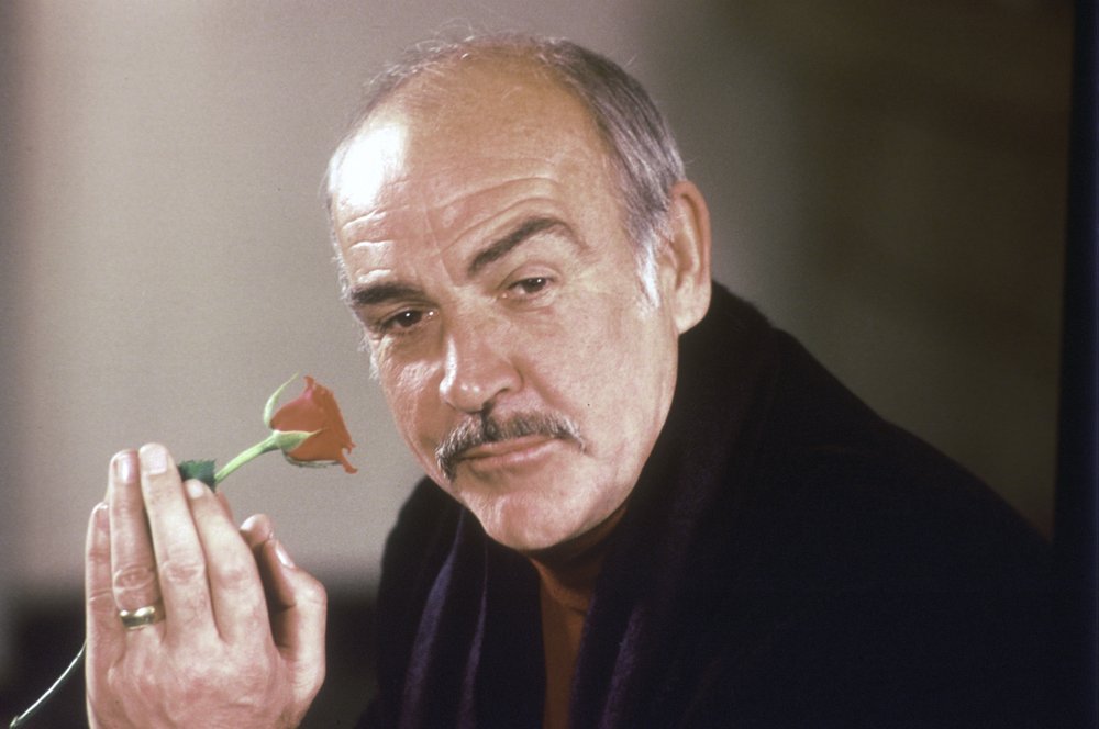 In this January 23, 1987 file photo, actor Sean Connery holds a rose in his hand as he talks about his new movie The Name of the Rose at a news conference in London.