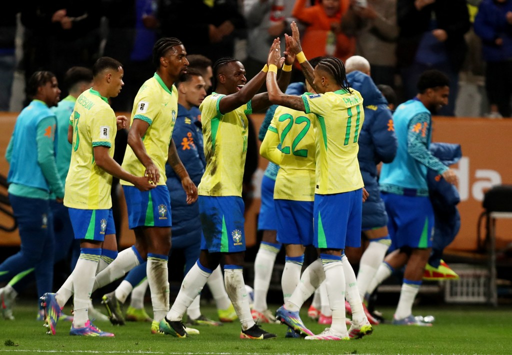 Brazil's Vinicius Junior celebrates scoring their first goal with Raphinha. (Reuters)