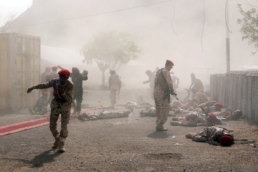 Soldiers lie on the ground after a missile attack in Aden, Yemen. (Reuters)
