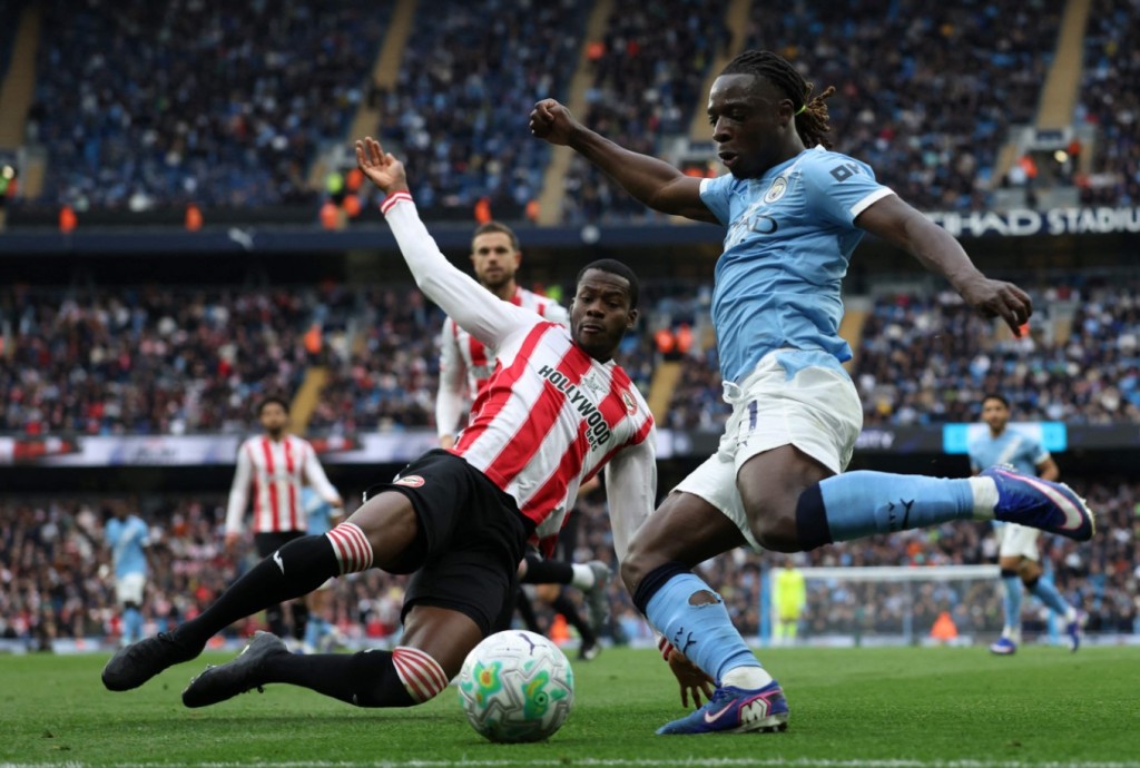 Jeremy Doku is challenged by Dango Ouattara. He has scored four goals in City’s last three games. AFP 