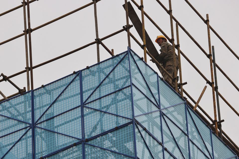 A man walks on a scaffolding at the construction site of the Beijing Xishan Palace apartment complex. (Reuters) A man walks on a scaffolding at the construction site of the Beijing Xishan Palace apartment complex. (Reuters)