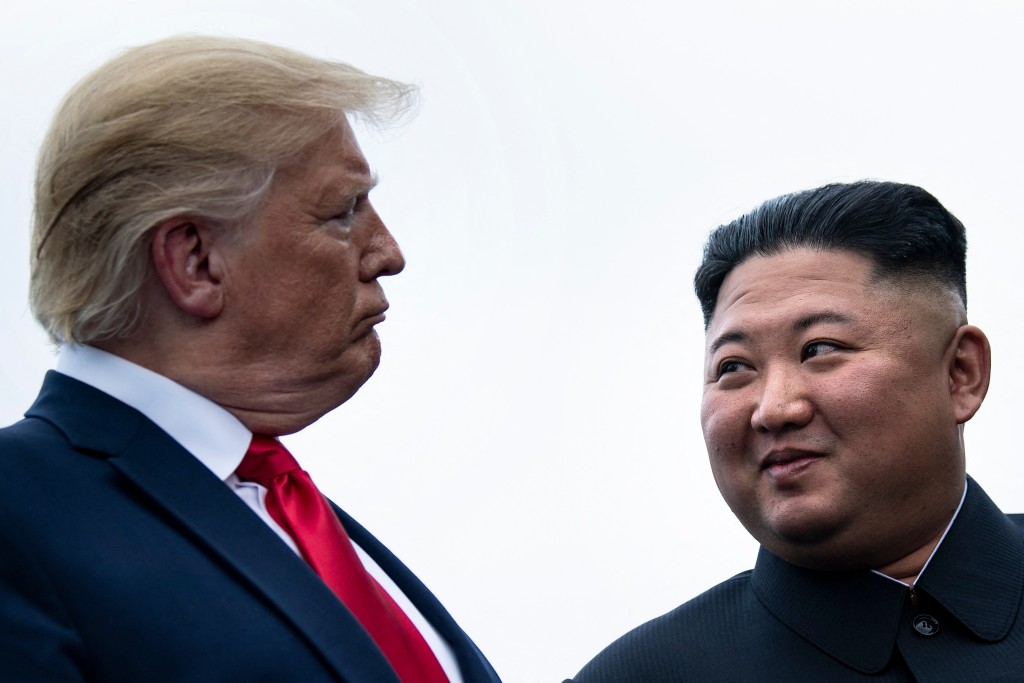 Photo by BRENDAN SMIALOWSKI / AFP  US President Donald Trump and North Korea's leader Kim Jong-un talk before a meeting in the Demilitarized Zone(DMZ) in Panmunjom on June 30, 2019.