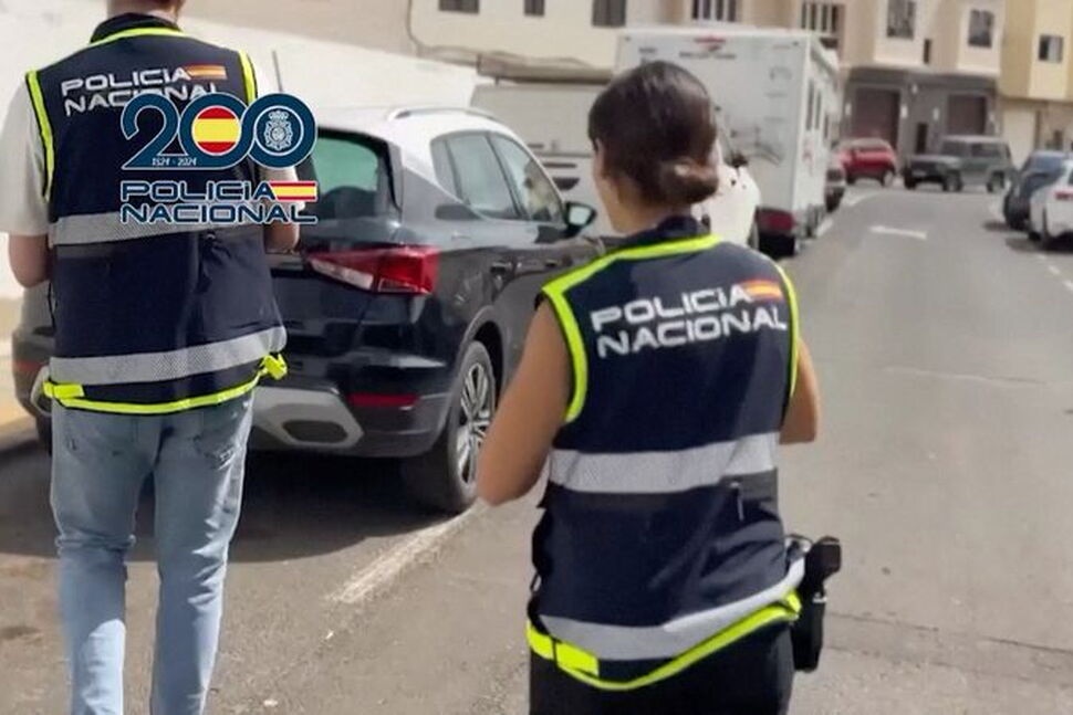 Police officers walk on a street. File Photo Spanish Police/Handout via REUTERS