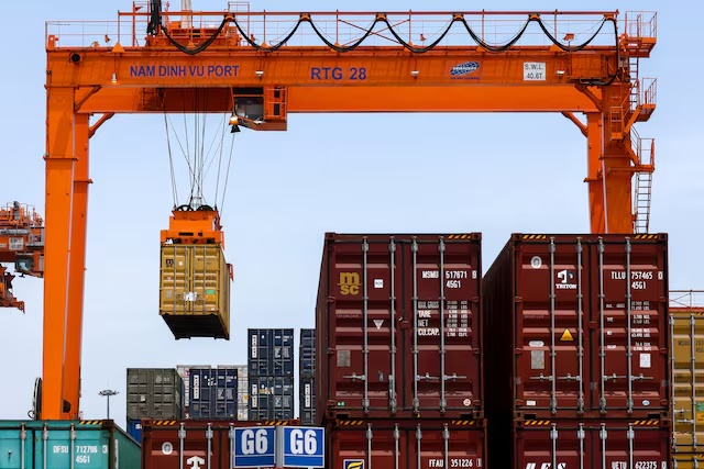 A container is loaded onto a cargo ship while docked at Hai Phong port in Hai Phong, Vietnam, April 16, 2025. REUTERS/Athit Perawongmetha/File Photo