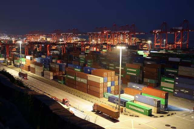 Gantry cranes stand near stacked shipping containers at Yangshan Port outside Shanghai, China, May 7, 2026. REUTERS/Go Nakamura/File Photo
