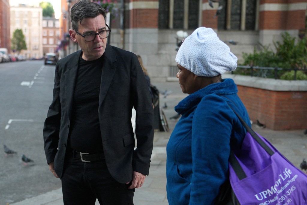 Labour Party leader Andy Burnham (L) talks to homeless person Hubar (surname withheld) as he meets homeless people on the street with staff from The Passage Homeless Charity in London early on July 20, 2026, just hours before taking the role as the country's new prime minister. (Photo by Christopher Furlong / POOL / AFP)