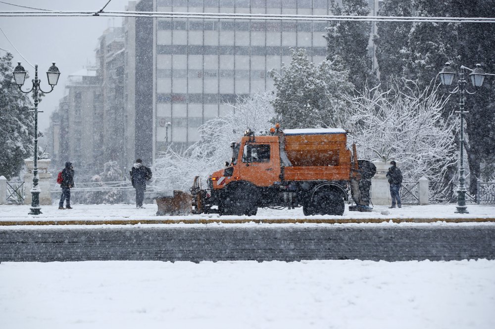 A snowplough on a main avenue at Syntagma square during a heavy snowfall in central Athens, Tuesday.