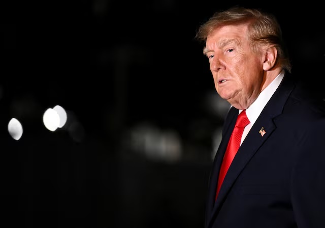 US President Donald Trump looks on while walking as he returns to the White House after travelling to Ohio, in Washington, DC, US, October 12, 2026. REUTERS/Annabelle Gordon 
