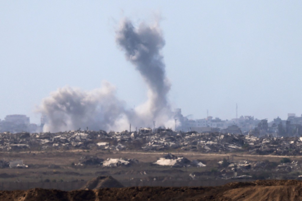 This picture taken from a position at Israel's border with the Gaza Strip shows smoke billowing amid Israeli bombardment of the besieged Palestinian territory on September 16, 2025. (Photo by Menahem Kahana / AFP)