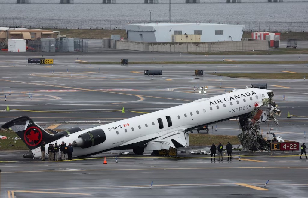Personnel of the National Transportation Safety Board (NTSB) inspect the wreckage of an Air Canada Express jet that collided with a ground vehicle at New York's LaGuardia Airport in Queens, New York, U.S., March 23, 2026. REUTERS/Shannon Stapleto