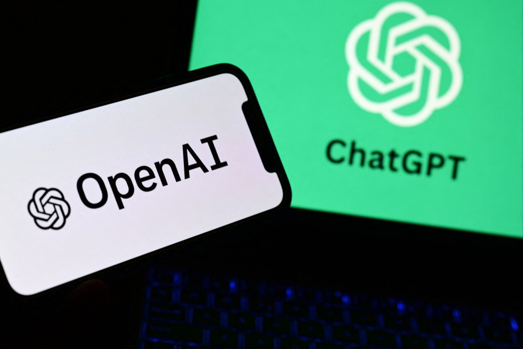 Photo by MARCO BERTORELLO / AFP  A photo taken on October 4, 2023 in Manta, near Turin, shows a smartphone and a laptop displaying the logos of the artificial intelligence OpenAI research laboratory and ChatGPT robot.