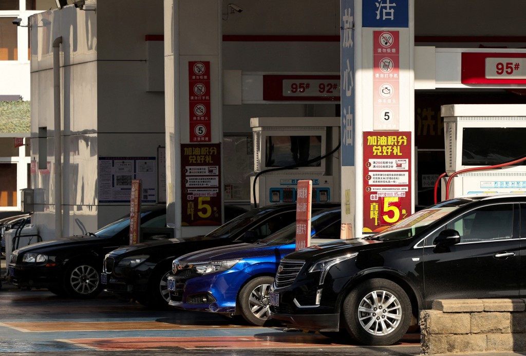 Cars are being fuelled at a Sinochem-Total gas station ahead of an announced fuel price hike, amid the U.S.-Israeli conflict with Iran, in Beijing, China, March 22, 2026. (Reuters)