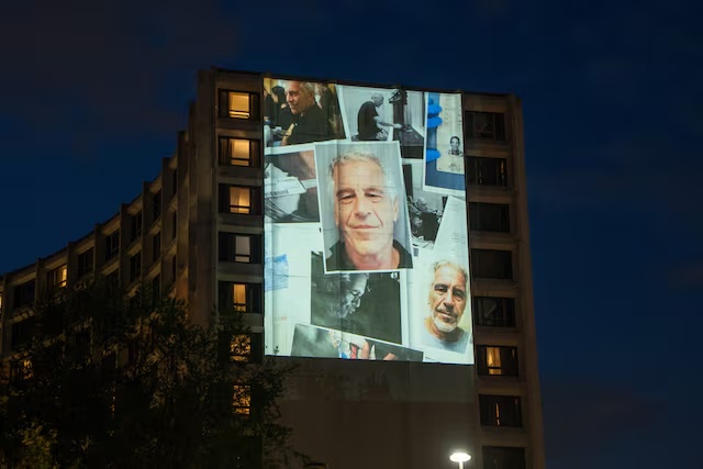 Photos of late financier and convicted sex offender Jeffrey Epstein are projected onto the Washington Hilton in Washington, D.C., U.S., April 24, 2026. REUTERS/Aaron Schwartz/File Photo