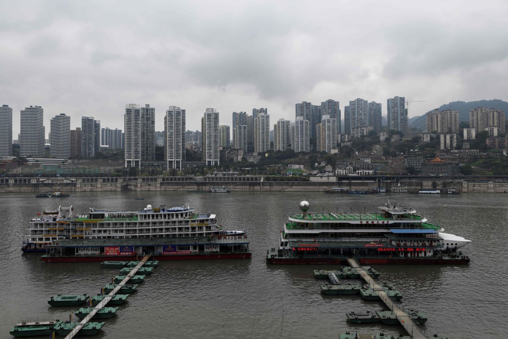 This picture taken on March 22, 2019 shows two cruises docked at a pier in southwest China's Chongqing Municipality. AFP