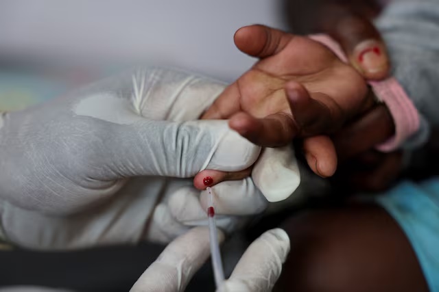 A nurse draws a blood sample from a child for an HIV test at a clinic in Diepsloot, north of Johannesburg, South Africa, March 12, 2025. REUTERS/Siphiwe Sibeko/File Photo