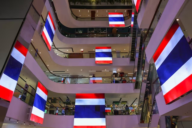 A view shows digital screens showing Thai national flags in support of the country inside a shopping mall, on the day the leaders of Cambodia and Thailand agreed to a ceasefire effective midnight, in a bid to bring an end to their deadliest conflict in more than a decade after five days of fighting, in Bangkok, Thailand, July 28, 2025. REUTERS/Chalinee Thirasupa/File Photo 