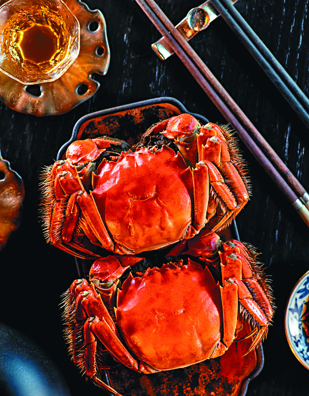  Clockwise from left:  Legacy House's steamed hairy crab with ginger and herb broth; steamed Shanghainese pork dumplings with hairy crab cream; and Cruise Restaurant and Bar's steamed flower crab and hairy crab xiao long bao. 