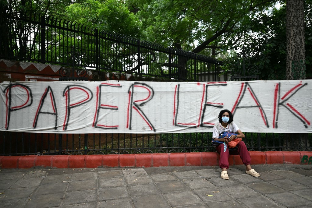 Photo by SAJJAD HUSSAIN / AFP  A Cockroach Janta Party (CJP) supporter sits at Jantar Mantar in New Delhi on July 23, 2026 during the ongoing protest to demand the resignation of India's Education Minister Dharmendra Pradhan over alleged NEET exam irregularities.