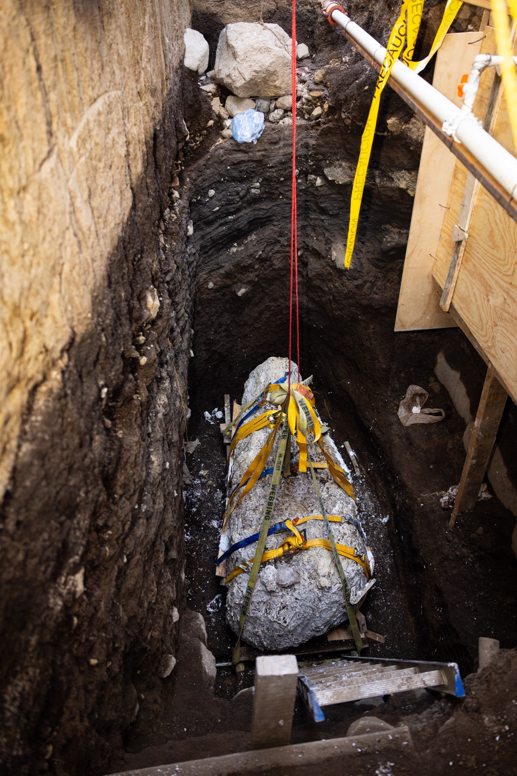 Photo by HANDOUT / EL SALVADOR'S PRESIDENCY PRESS OFFICE / AFP  This handout image released by El Salvador's Presidency shows archaeologists extracting a pre-Hispanic burial estimated to date to 850 B.C. at an archaeological site in Antiguo Cuscatlan, El Salvador, on July 21, 2026.