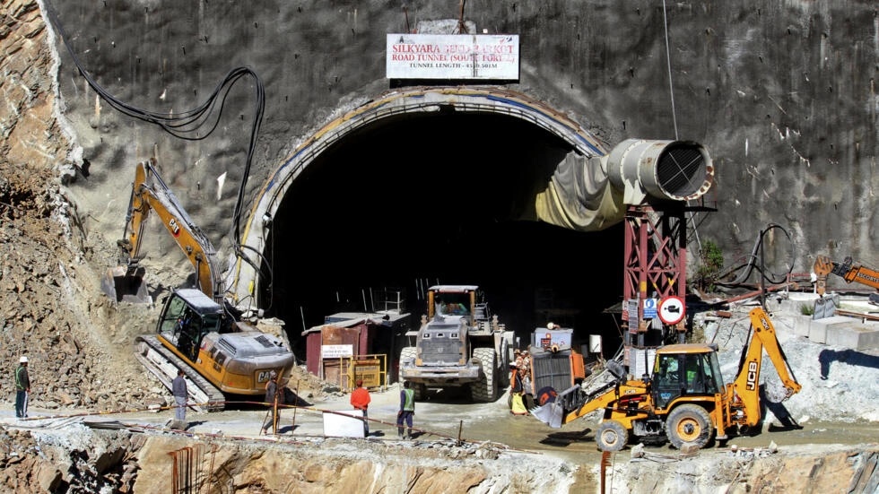 Rescue workers stand at an entrance of the under-construction road tunnel, days after it collapsed. (AFP) Rescue workers stand at an entrance of the under-construction road tunnel, days after it collapsed. (AFP)