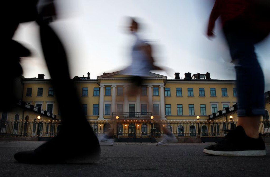 People walk past the Presidential Palace in Helsinki, Finland July 13, 2018. REUTERS