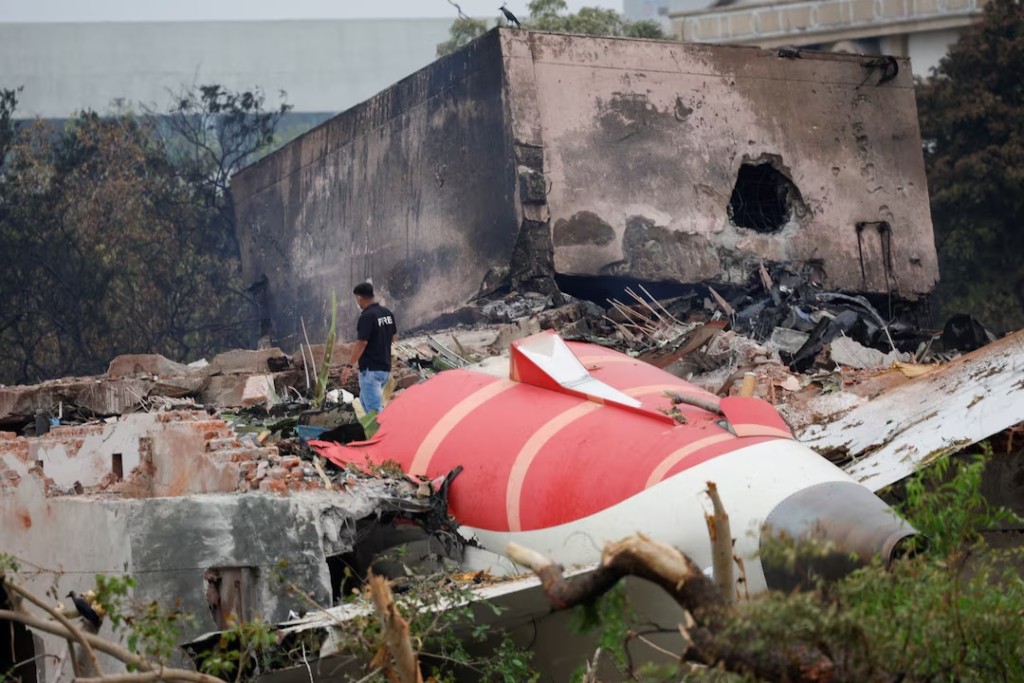 A fire offical stands next to the crashed Air India Boeing 787-8 Dreamliner aircraft, in Ahmedabad, India, June 13, 2025. REUTERS/Adnan Abidi/File Photo 