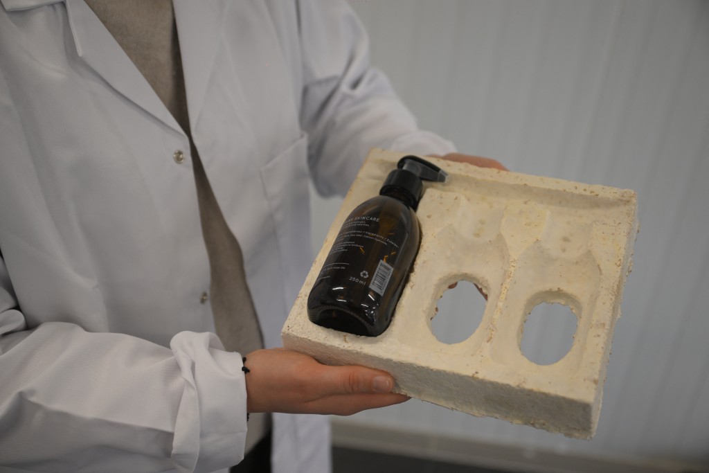 Photo by NICOLAS TUCAT / AFP  An employee holds a soap bottle packaging made from dried mycelium and sawdust at the Permafungi production line in Brussels on November 12, 2025.