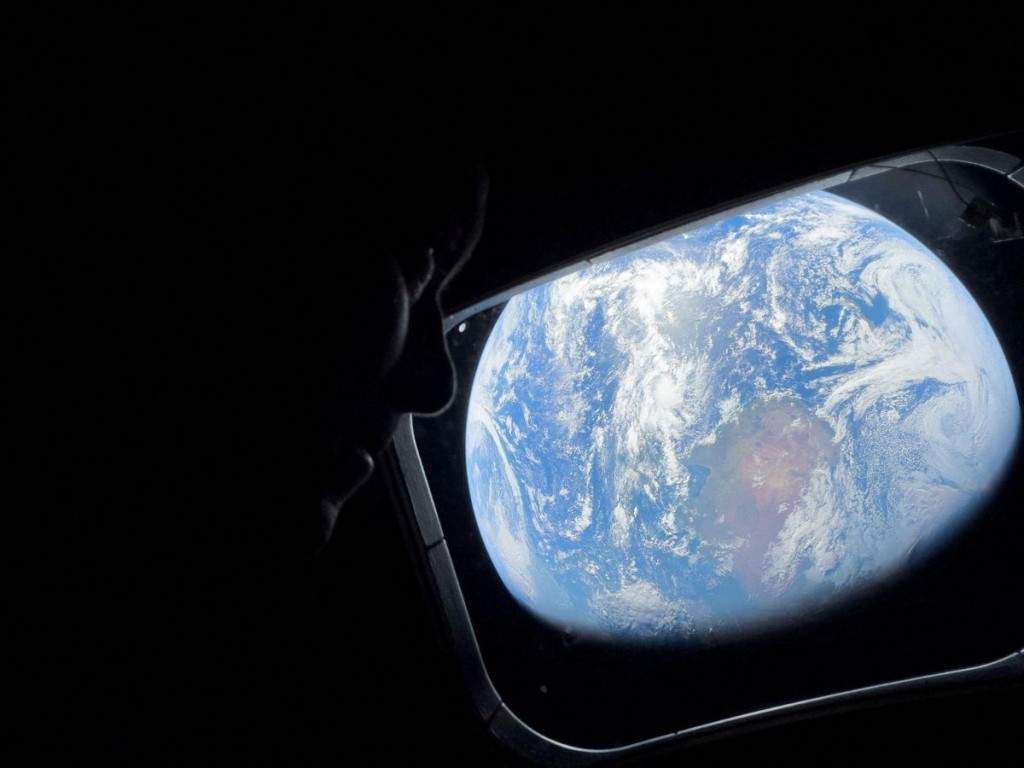 NASA astronaut and Artemis II Commander Reid Wiseman peers out of one of the Orion spacecraft's main cabin windows. Reuters